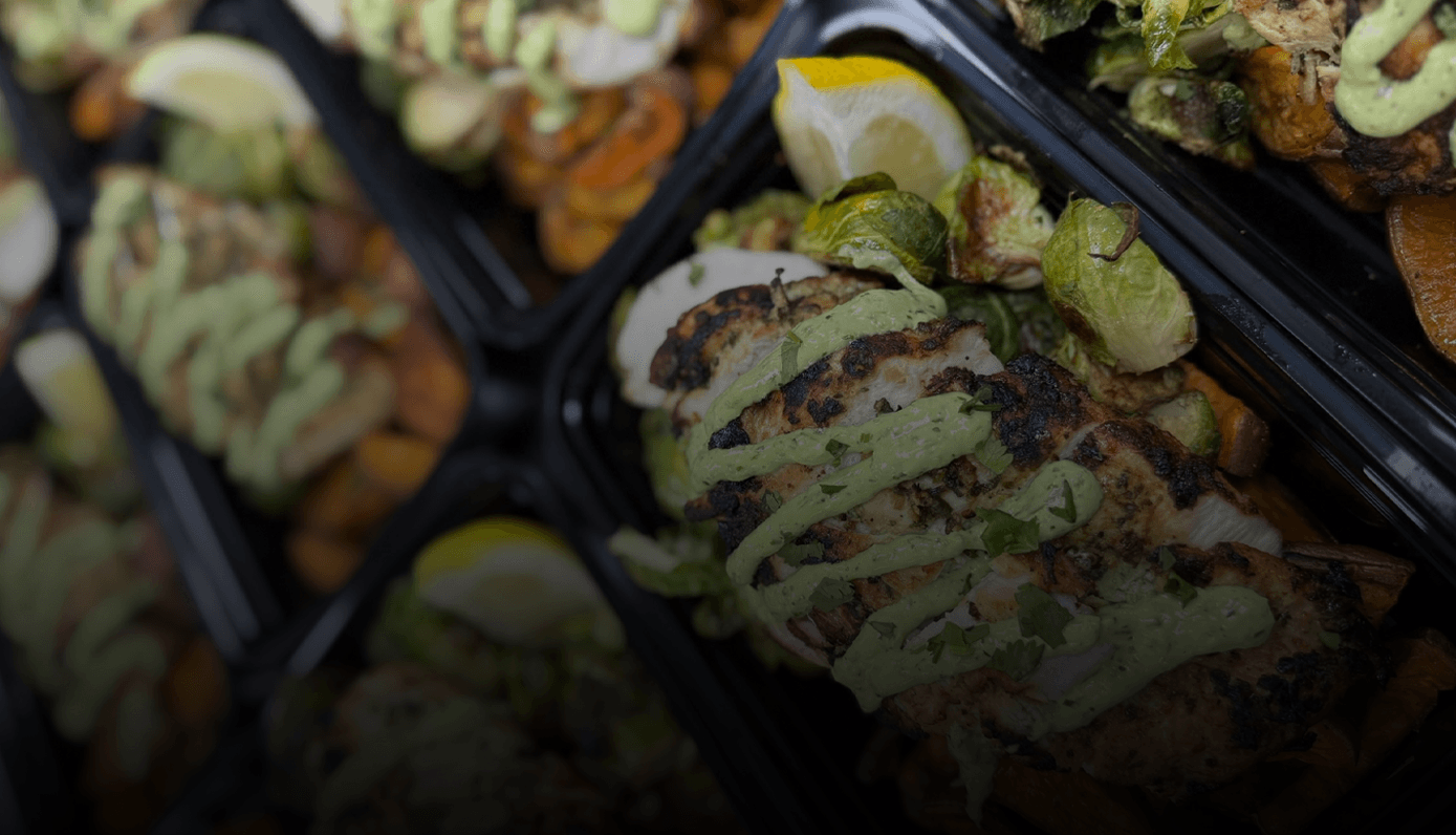 Chef-prepared Fuel Club meals: herb chicken with green sauce, brussels sprouts and sweet potato